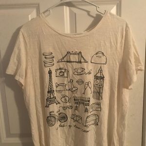 A shirt that has Paris themed pictures on it.